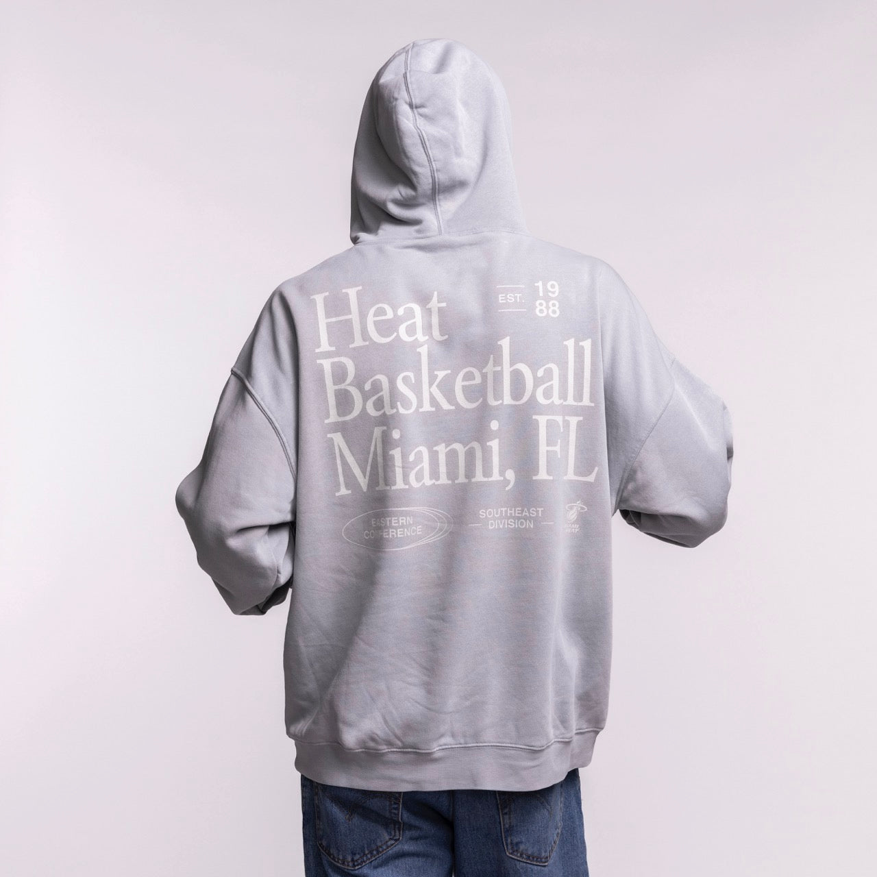 A person faces away from the camera wearing a gray Court Culture 