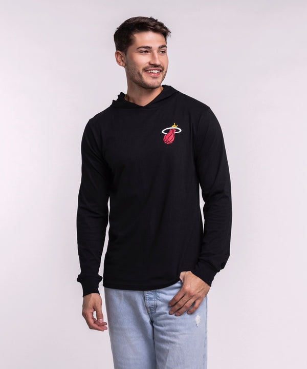 A man smiles in the Sportiqe Miami HEAT Solano Logo Hoodie by Sportiqe, featuring a black, standard fit, long-sleeve design with the Miami Heat logo. Made of 100% cotton and machine washable for easy care.