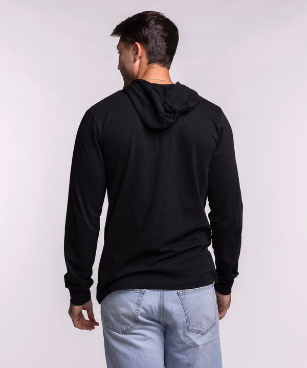 A man smiles in the Sportiqe Miami HEAT Solano Logo Hoodie by Sportiqe, featuring a black, standard fit, long-sleeve design with the Miami Heat logo. Made of 100% cotton and machine washable for easy care.