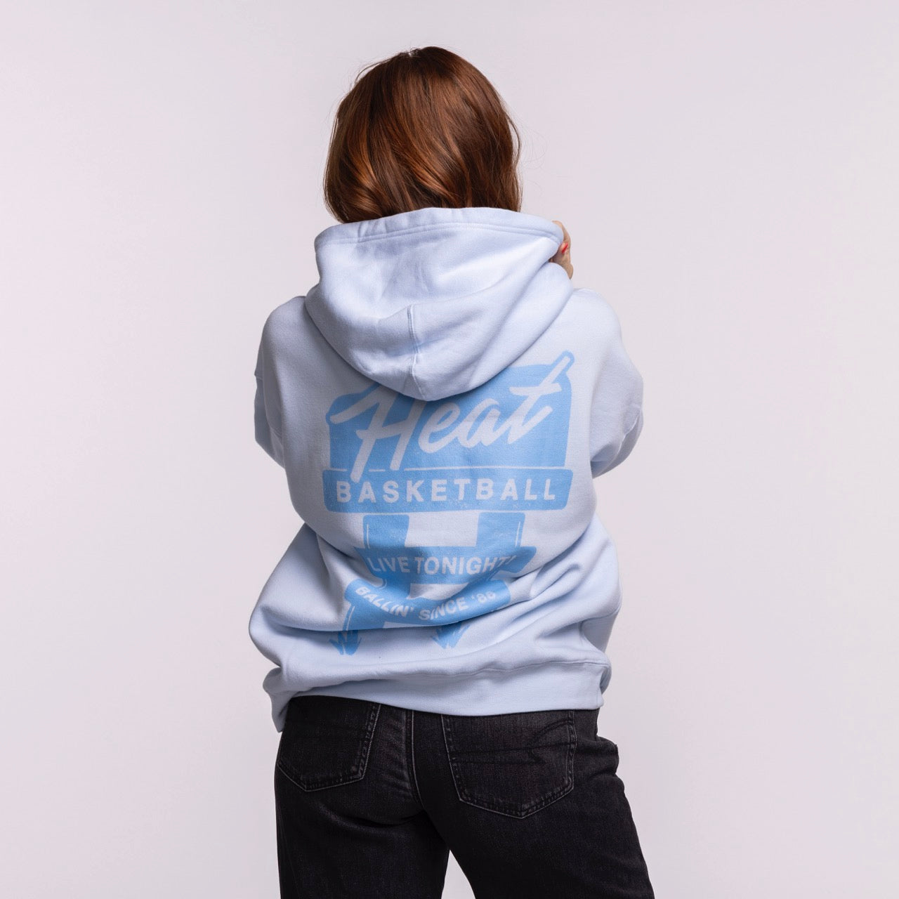 A person with long brown hair, seen from behind, wears the Court Culture Original Vice Nights 