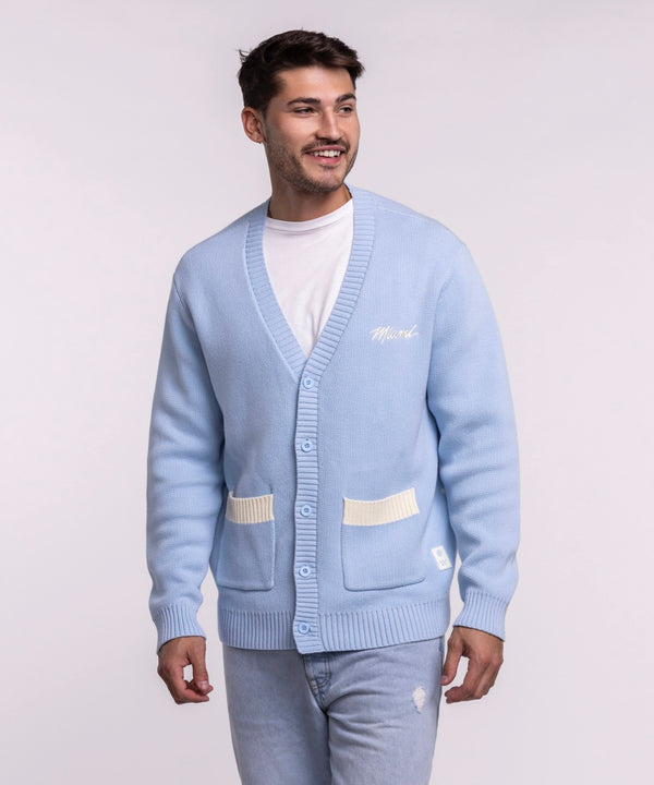 A man smiles, looking to the side, wearing the Court Culture X The Wild Collective Original Vice Nights 