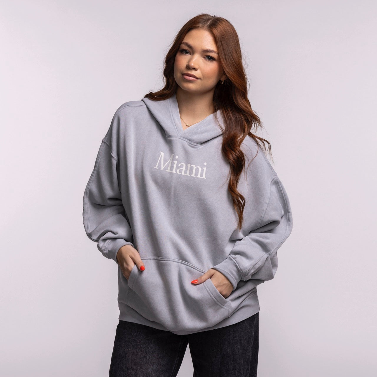 A person with long, wavy brown hair wears the Court Culture 