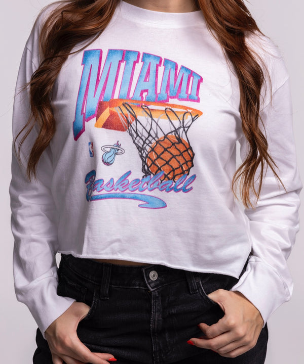 A young woman with long, wavy brown hair smiles in a Court Culture Original Vice Nights 