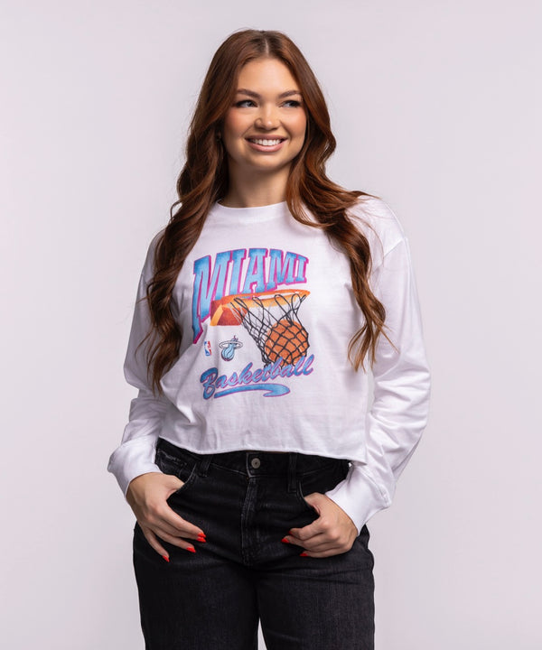 A young woman with long, wavy brown hair smiles in a Court Culture Original Vice Nights 