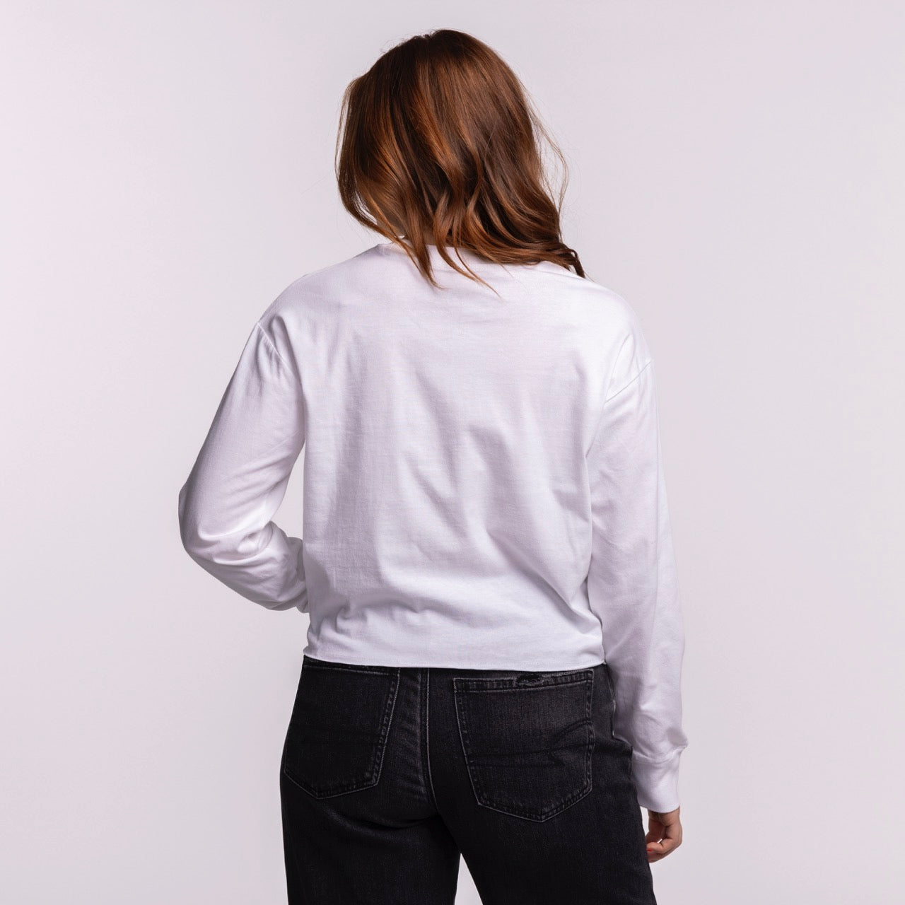 A woman with long brown hair faces away from the camera, wearing a Court Culture Original Vice Nights 