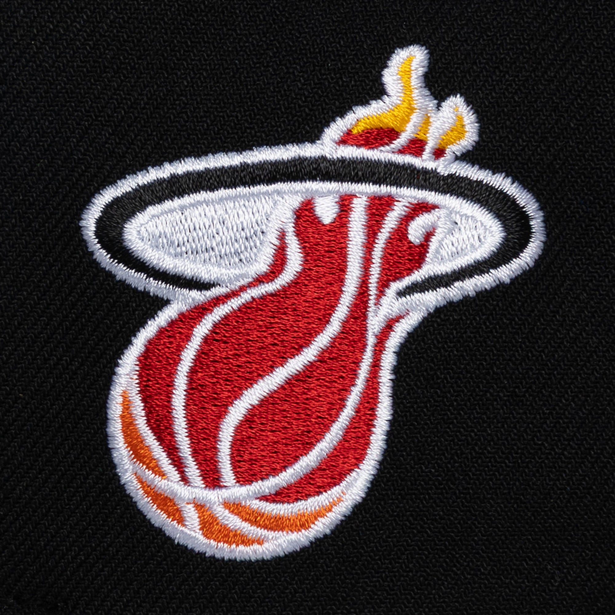 The Mitchell & Ness Miami HEAT Script Snapback features an embroidered flaming basketball logo in yellow, red, white, and orange on black polyester. One size fits most; spot clean only.