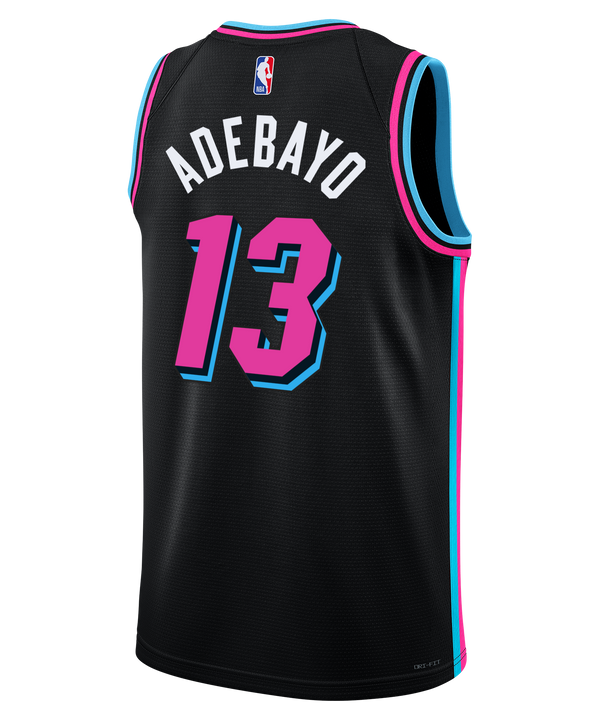 The Nike Bam Adebayo Original Vice Nights Youth Swingman Jersey features Miami's stylized script, number 13, sponsor and NBA logos, blue/pink trim, and sweat-wicking Dri-FIT tech for comfort.