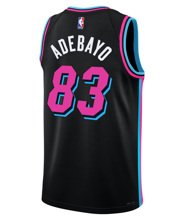 The Nike Bam Adebayo Original Vice Nights “83-Point Game” Swingman Jersey features black fabric with pink and blue trim, “Miami” in pink script, #83 in pink with blue outline, plus Nike and Robinhood logos on the chest.