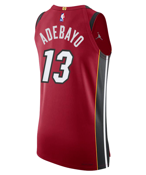 The Bam Adebayo Nike Jordan Brand Miami HEAT Statement Red Authentic Jersey features the number 13 in white, black and yellow side panels, Jordan and Robinhood logos, plus NBA, Miami Heat, and 2006 Championship patch near the hem.