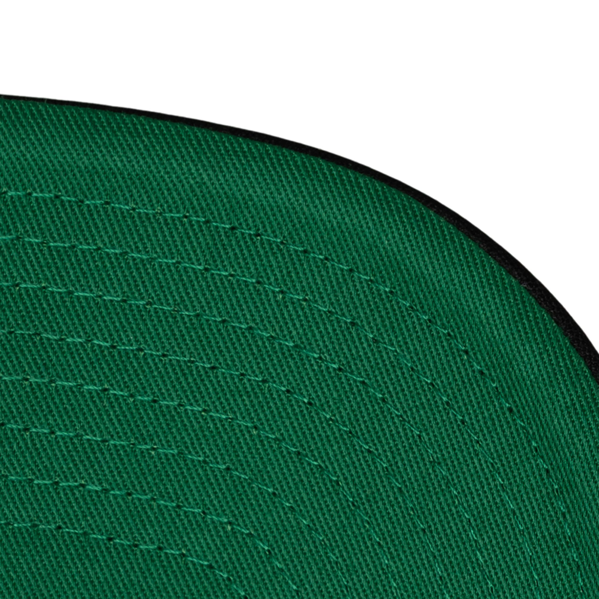 Close-up of the green brim and black edge on the Mitchell & Ness Miami HEAT Division Champ Trucker Snapback, featuring visible stitching. Adjustable fit; one size fits most. Set against a white background.
