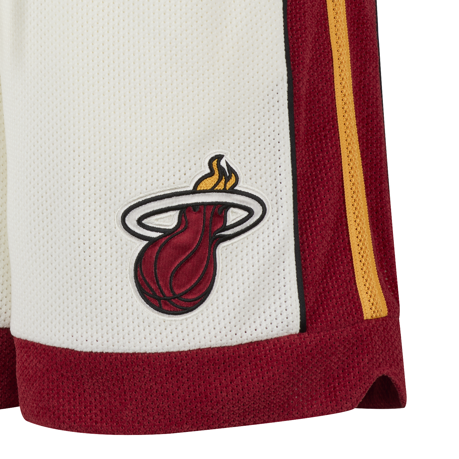 Close-up of white Nike Miami HEAT LeBron James Forever King Shorts, featuring a red and yellow stripe and the Miami Heat logo with a flaming basketball embroidered on the side for sweat-wicking comfort.