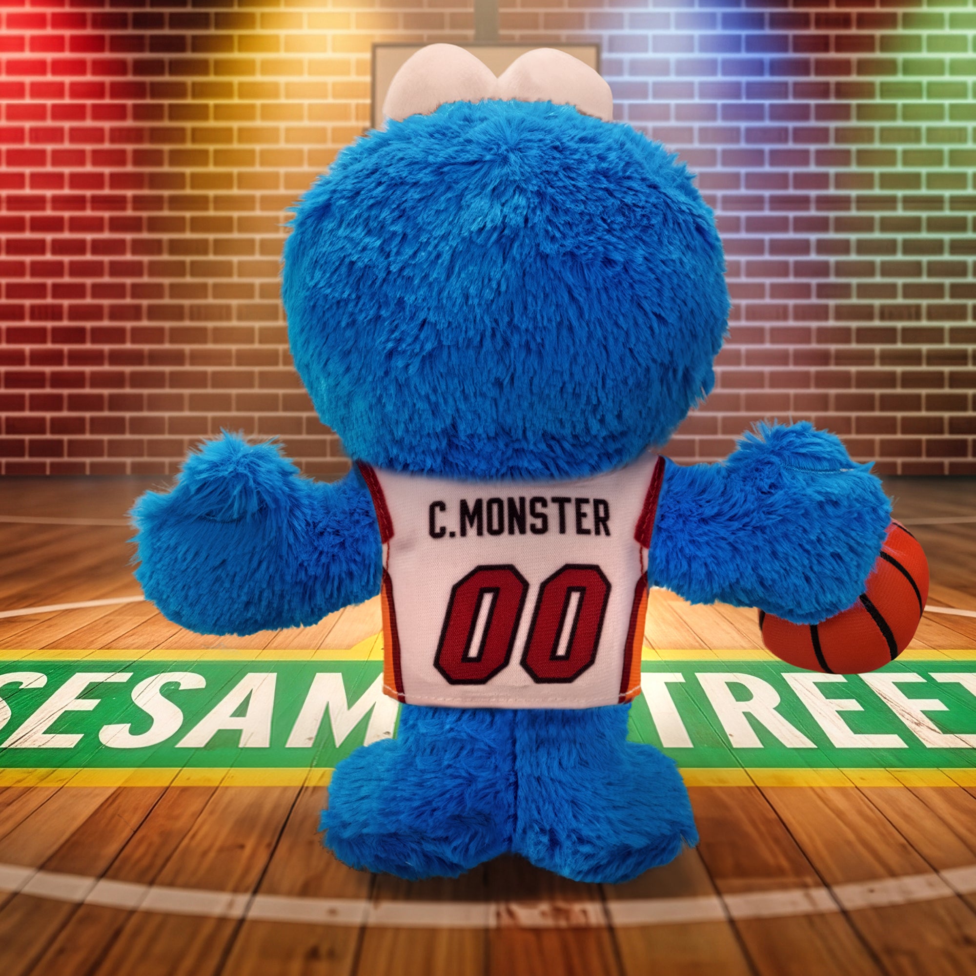 A blue, furry Miami HEAT Cookie Monster Association Plushie from Bleacher Creatures stands on a basketball court marked “Sesame Street,” bringing together the playful spirit of Sesame Street and the excitement of Miami HEAT basketball.
