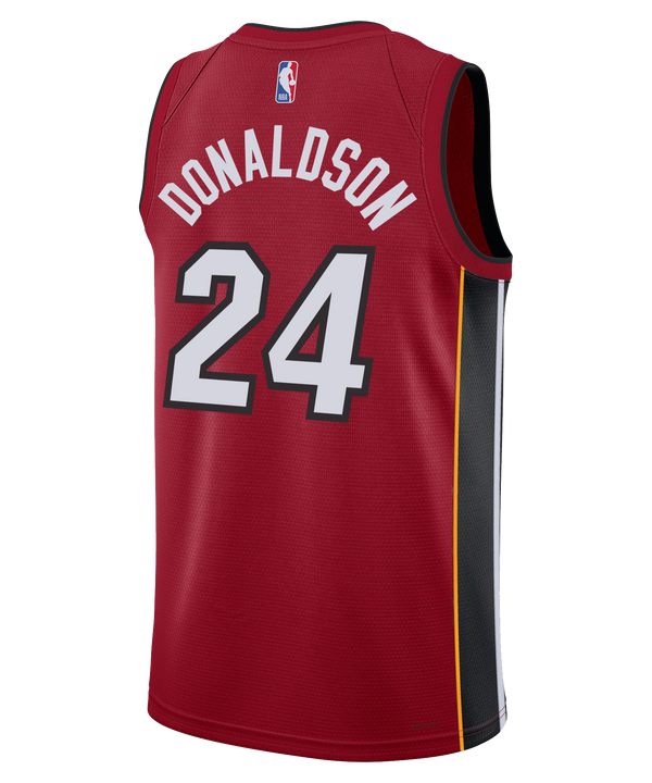 The Tre Donaldson Nike Jordan Brand Miami HEAT Statement Red Swingman Youth Jersey by Nike features the Miami Heat team design in bold red, with the number 24 in white and gray lettering. This youth jersey showcases prominent sponsor and NBA logos, incorporates Dri-FIT technology for advanced moisture-wicking performance, and is detailed with black and yellow side panels. It is displayed against a white background.