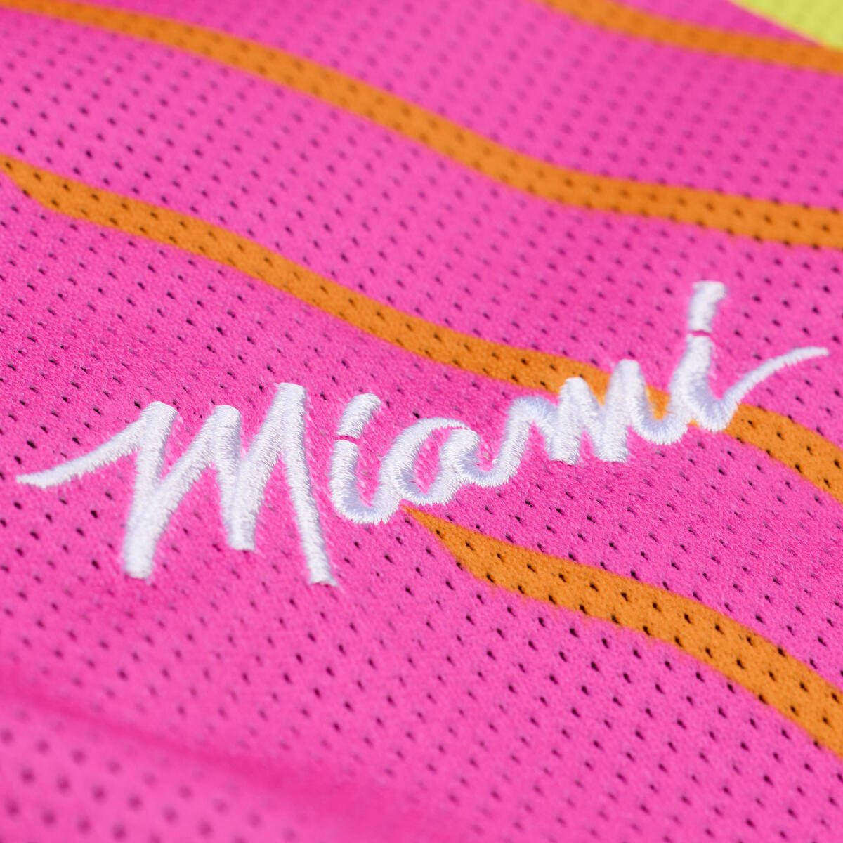 Close-up of pink mesh fabric with orange wavy stripes on the Court Culture x Mitchell & Ness Original Vice Nights 