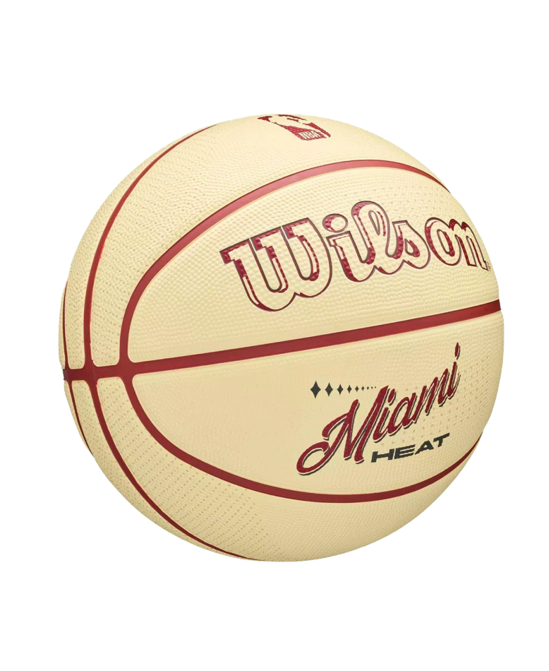 Cream-colored Wilson Miami HEAT Modern Rubber Basketball with red seams and red and burgundy branding, a durable choice similar to a 7 pressure lock outdoor ball.