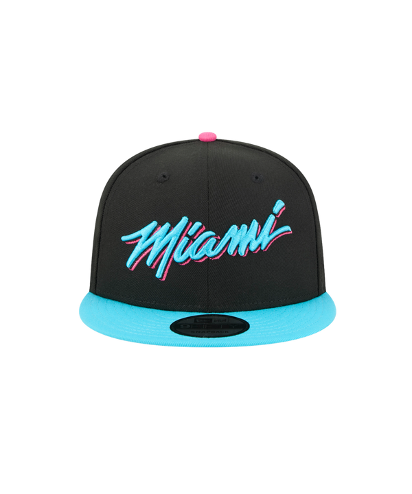 The New Era Miami HEAT Original Vice Nights Snapback features a black design with a bright blue brim, stylized pink and blue Miami embroidery, a pink top button, polyester fabric, one size fits most, and is spot clean only.