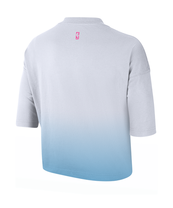 The Nike Miami HEAT Original Vice Nights Women's Boxy Tee is a loose-fit, short-sleeve cotton shirt in a white and light blue gradient, featuring a pink Nike Swoosh and 