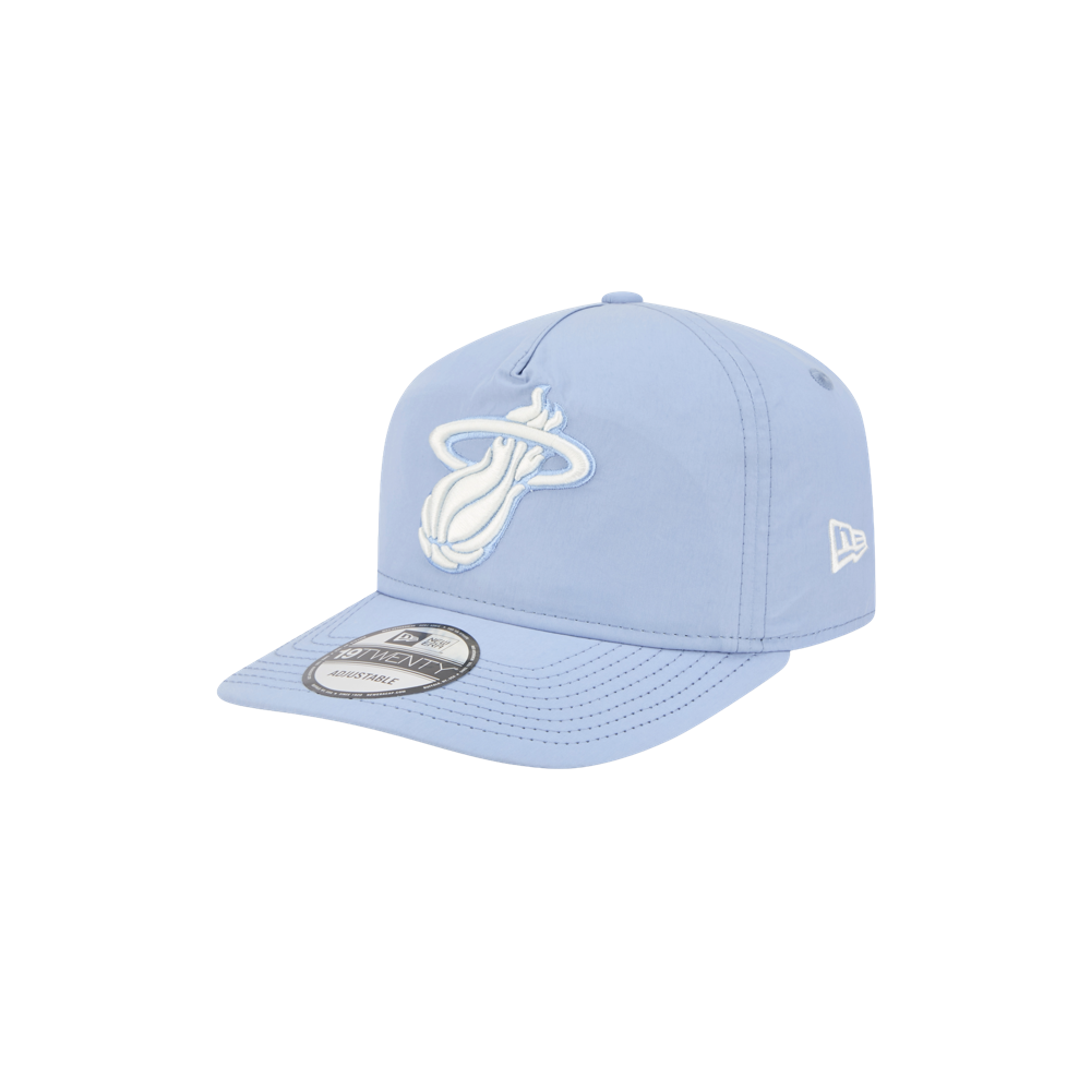 The New Era Miami HEAT Nylon Blue Snapback features a light blue cotton nylon build, a pre-curved visor, white Miami Heat logo in front, and New Era logo on the side, shown against a plain white background.