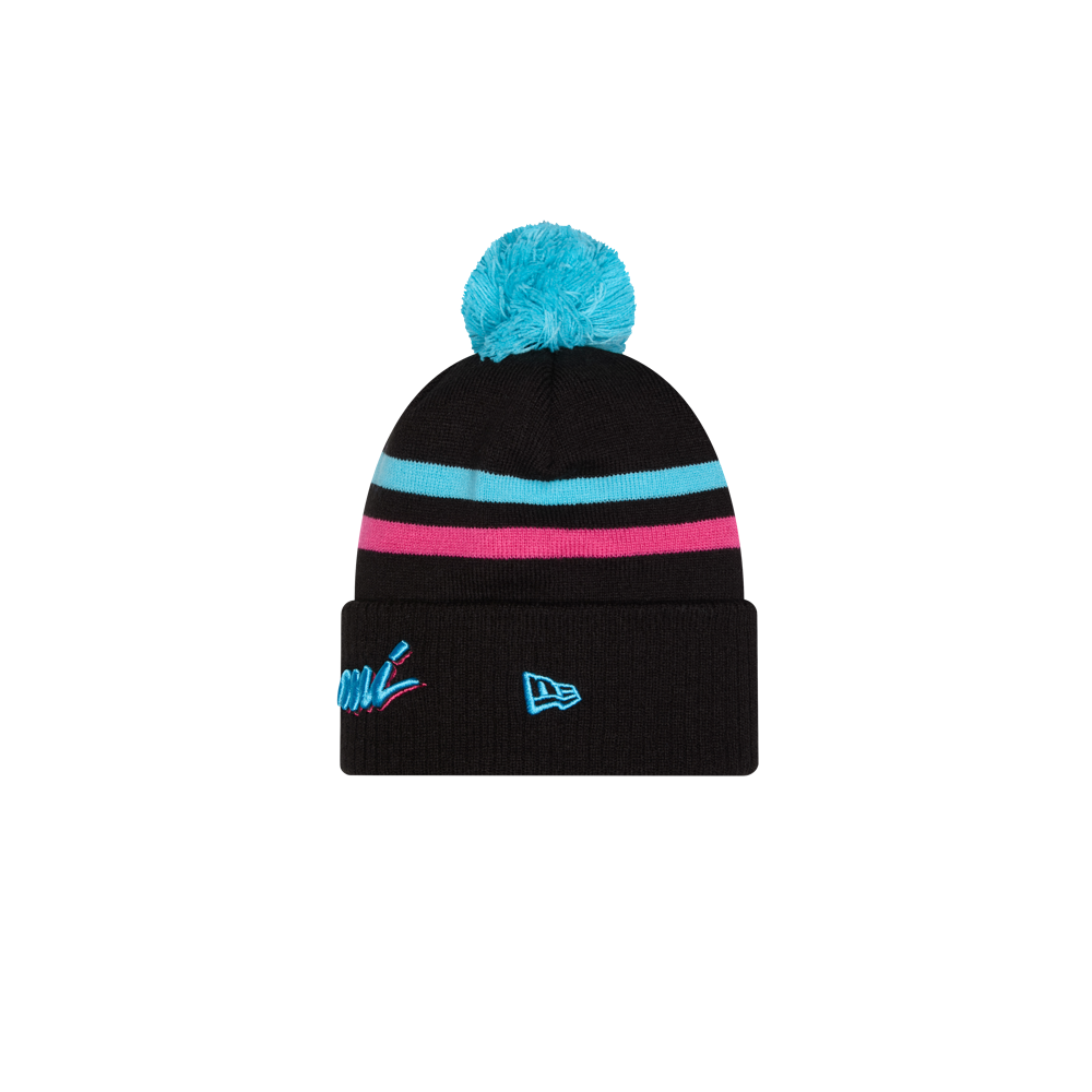 The New Era Miami HEAT Original Vice Nights Knit is a black acrylic beanie with turquoise pom-pom, blue and pink stripes, and embroidered logos on the folded brim. One size fits most; spot clean for best care.