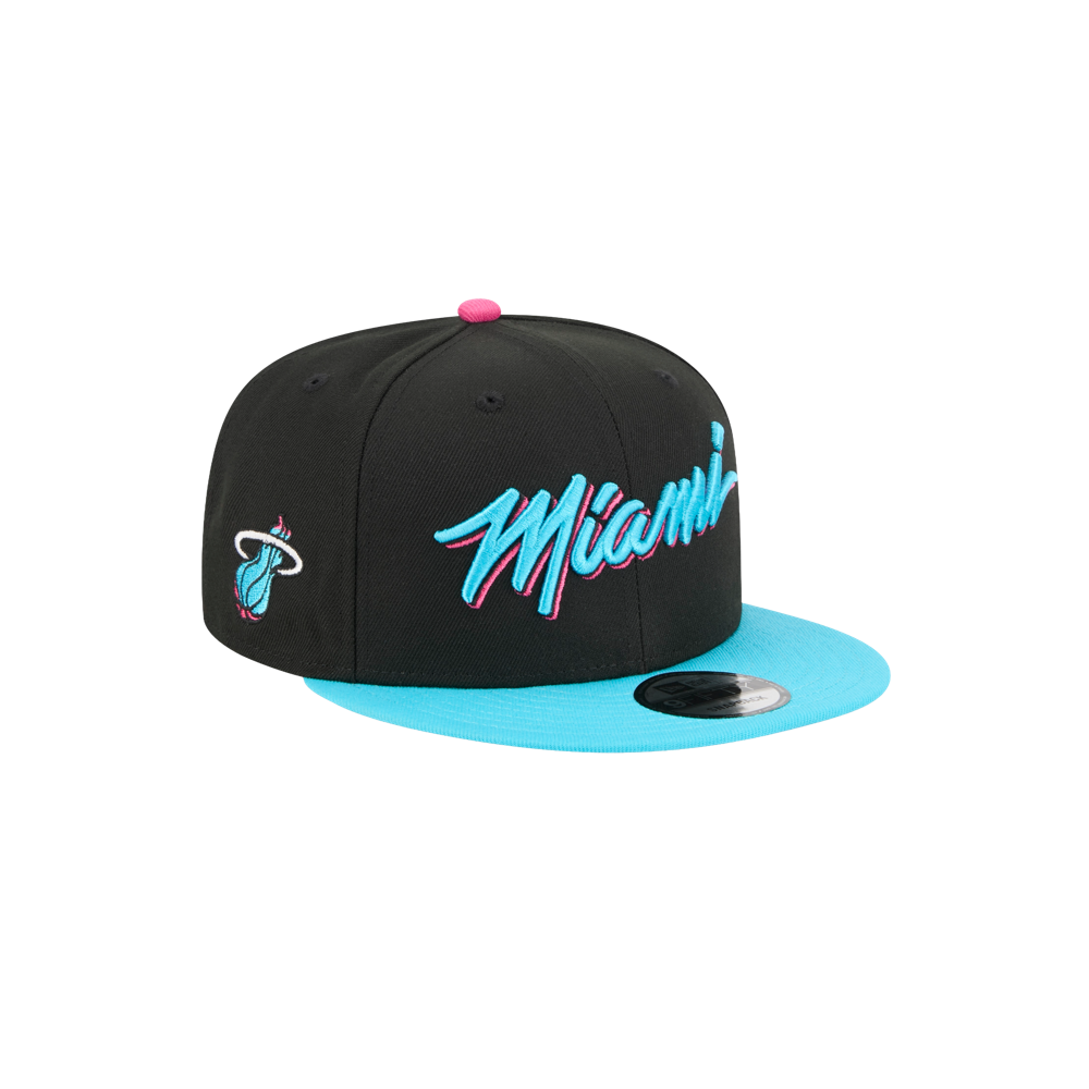 The New Era Miami HEAT Original Vice Nights Snapback features a black and turquoise polyester design, blue and pink 