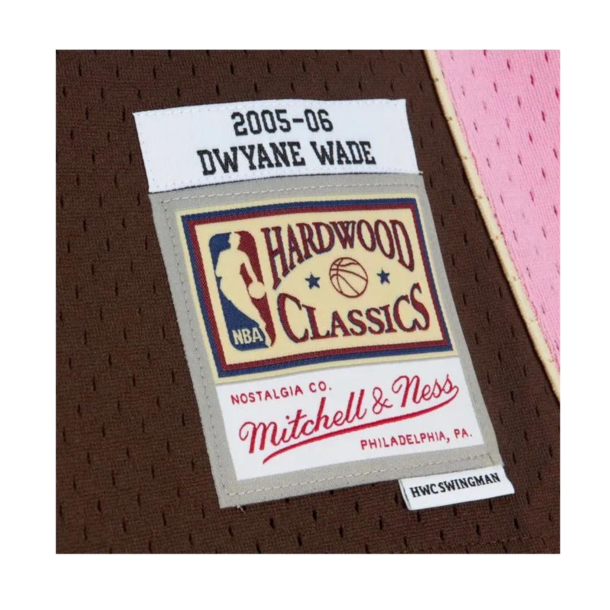 Brown Miami HEAT jersey tag with 2005-06 Dwyane Wade and Mitchell & Ness Hardwood Classics logo. - Dwyane Wade Mitchell & Ness Miami HEAT 2005-06 Brown Bacon Jersey