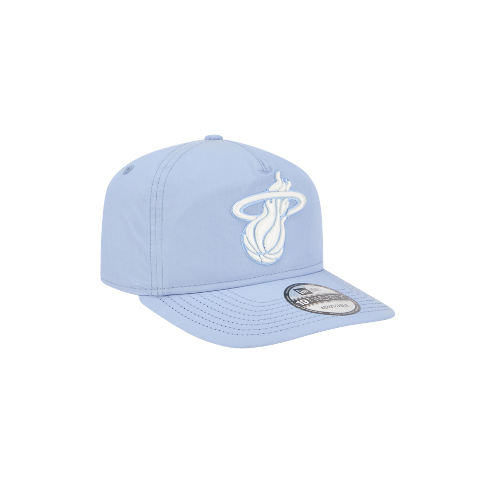 The New Era Miami HEAT Nylon Blue Snapback features the team's white logo on light blue, a pre-curved visor, and adjustable fit for comfort and style.