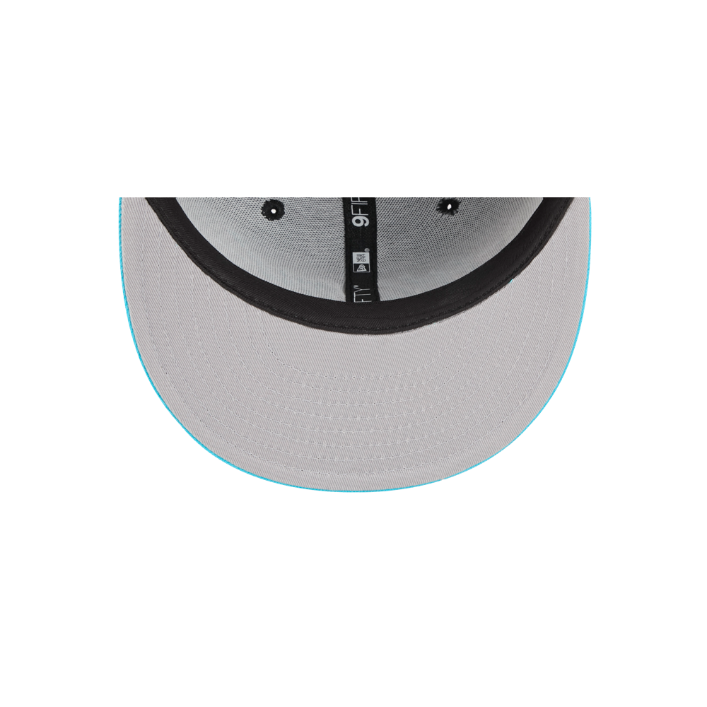 A top-down view of the underside of the New Era Miami HEAT Original Vice Nights Snapback shows a gray polyester build, black inner band, and light blue brim edge. Stitching and structure are visible. One size fits most; spot clean recommended.
