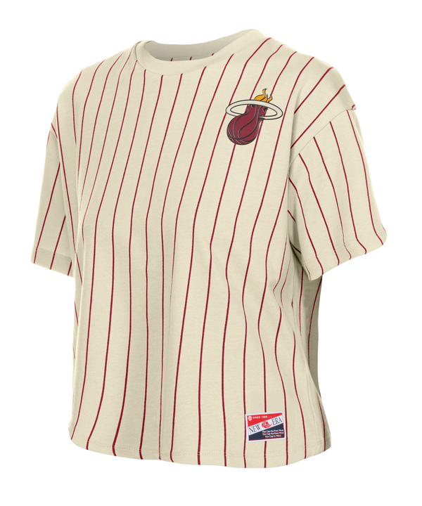 The New Era Miami HEAT Stripe Logo Women's Crop Top features cream fabric with red pinstripes, a Miami Heat logo on the left chest, and an NBA tag at the hem. Made of cotton-polyester in a relaxed cropped fit. Machine wash cold recommended.