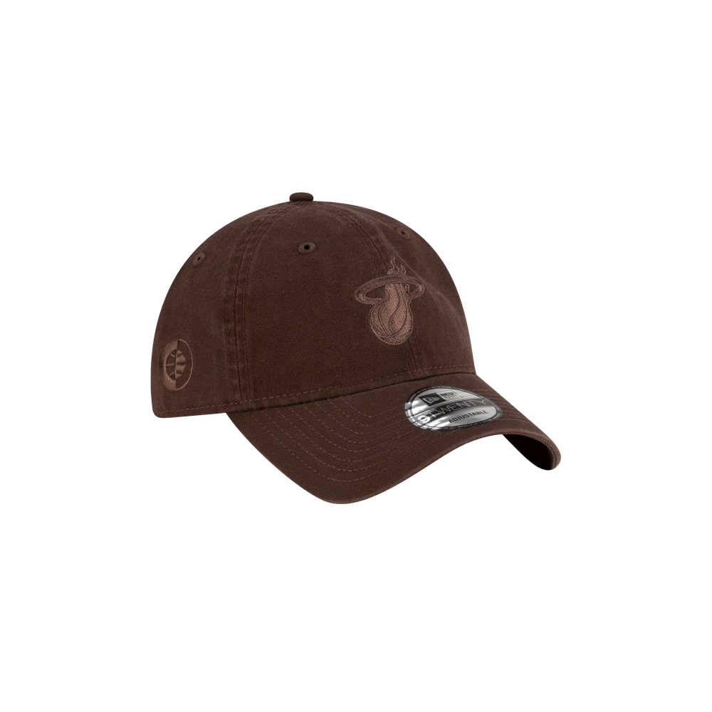 The Court Culture Ball & Flame Chocolate Dad Hat by Court Culture is a brown cotton cap with a curved brim, featuring the Miami Heat flaming basketball logo embroidered on the front, a silver brim sticker, ventilation eyelets, and one-size fit.