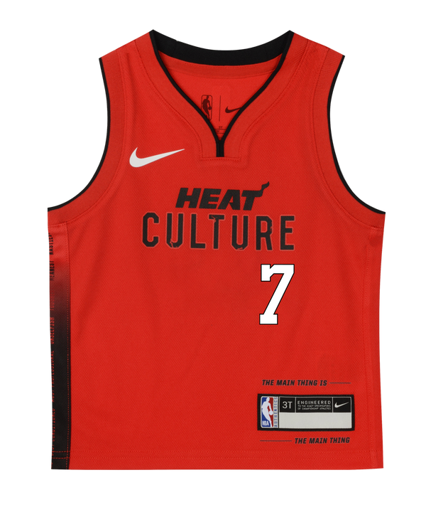 The Giannis Antetokounmpo Nike HEAT Culture: Blood Red Kids Replica Jersey by Nike features bold black trim, the number 7 in white, HEAT CULTURE text, official Nike and NBA logos, and a special patch reading THE MAIN THING IS THE MAIN THING—an iconic representation of the HEAT Culture uniform inspired by Pat Riley’s leadership.