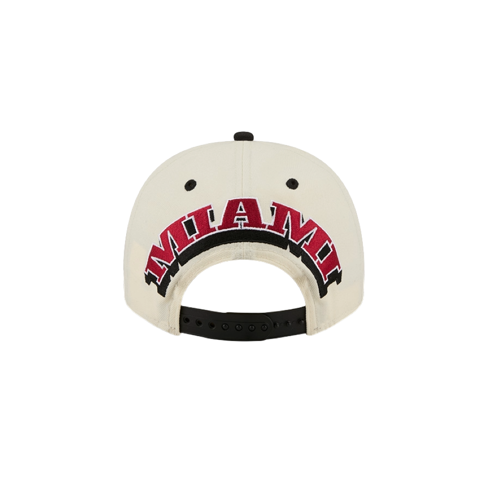 A view of the New Era Miami HEAT Logo Wordmark Snapback from the back showcases bold MIAMI embroidery in red and black above its adjustable strap. Crafted by New Era from durable polyester for everyday comfort, this stylish snapback offers a one-size-fits-most design—ideal for daily wear. Spot clean to keep your cap looking fresh and crisp.