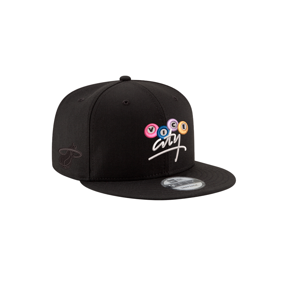 The Court Culture x New Era Vice City Billiards Snapback is a black polyester hat with colorful, circular VOCAL letters above art in white script, side logo embroidery, and adjustable fit. Spot clean only.