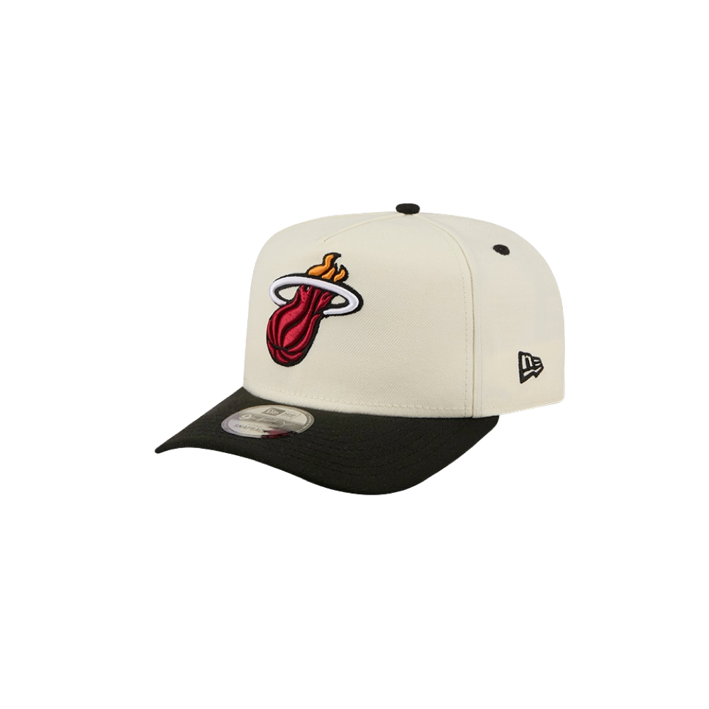A white and black New Era Miami HEAT Logo Wordmark Snapback, made from polyester, features the Miami Heat logo on the front and the New Era logo on the side. Displayed on a plain white background, this hat is designed as one size fits most and is easy to spot clean for everyday wear.