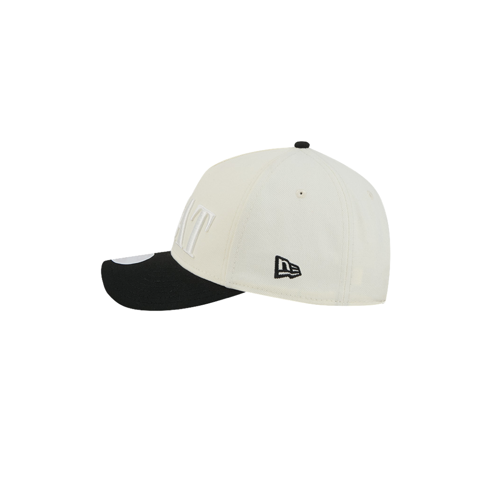The New Era Miami HEAT 2-Tone Tonal Women’s Snapback is a white and black adjustable baseball cap, shown from the side with a black visor and an embroidered New Era logo near the back. Designed as one size fits most, this hat offers added convenience.