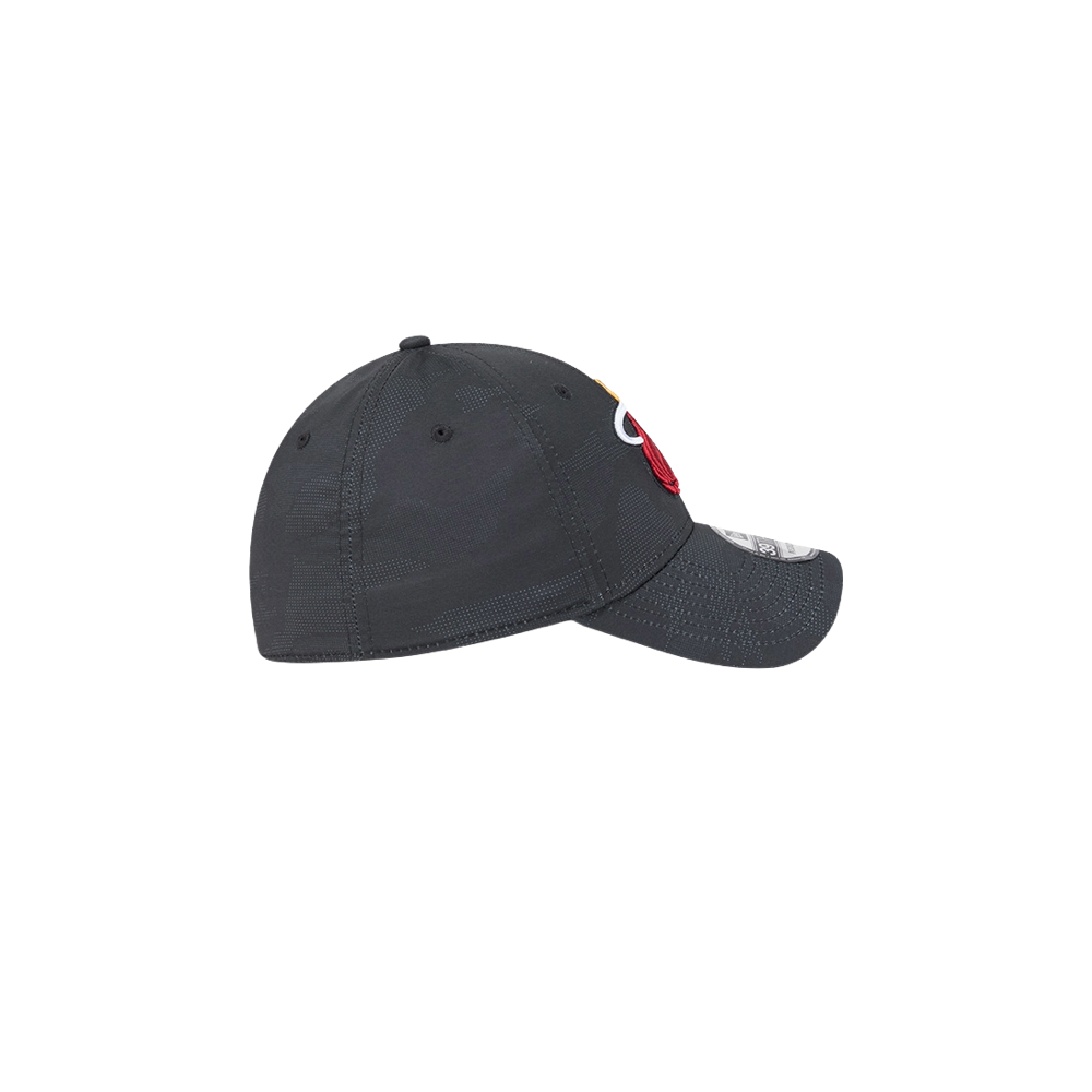 The New Era Miami HEAT Tonal Camo Flex Fit Hat, in dark gray with visible stitching and a partial front patch, is made from polyester spandex. Shown side view on a white background. Easy to spot clean.
