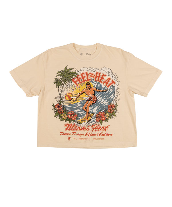 The Court Culture x Duvin Surf Crop is a beige midweight cotton tee with retro artwork of a basketball player, palm trees, waves, and flowers. “Feel the Heat” and “Miami Heat” in vibrant lettering celebrate Court Culture style.
