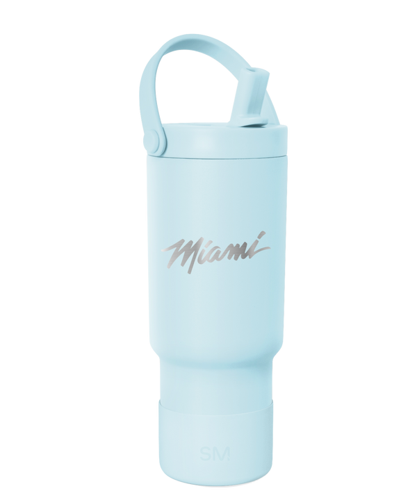 The Simple Modern Miami HEAT Original Vice Nights 24oz Pivot Tumbler is a light blue, BPA-free tumbler with double wall insulation, a handle, and a leakproof straw lid, featuring “Miami” in silver script on the front.