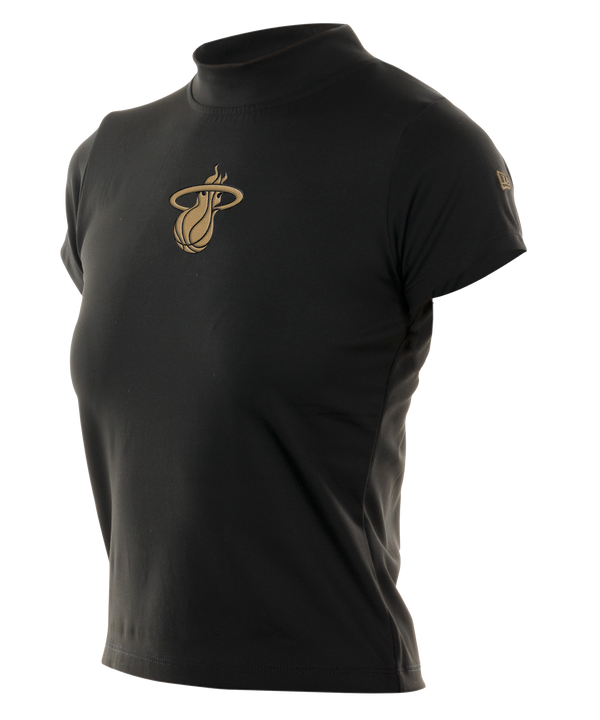 The New Era Miami HEAT Women's Mock Neck Tee is a black fitted short-sleeve shirt with a gold Miami Heat basketball logo on the chest and a small gold emblem on the sleeve, made from a nylon-elastane blend, shown on a white background.