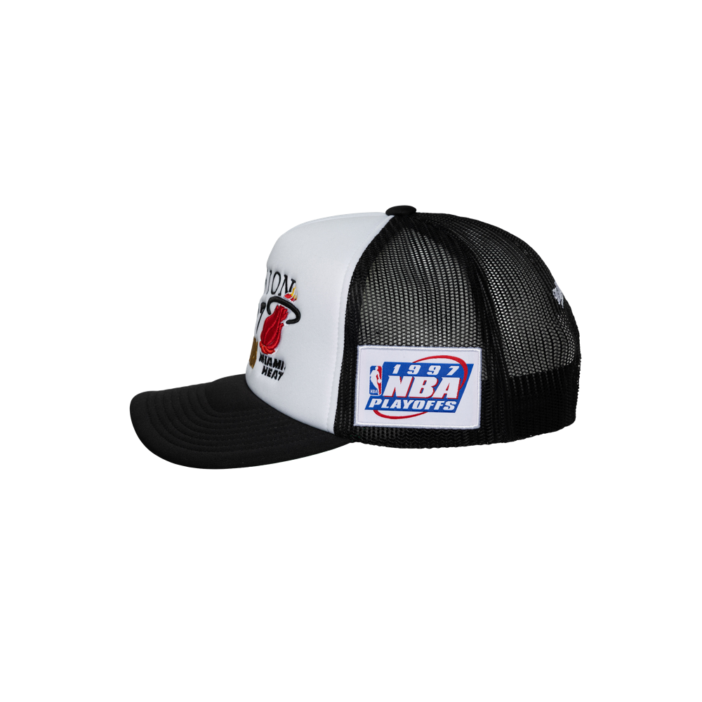 The Mitchell & Ness Miami HEAT Division Champ Trucker Snapback is a black and white polyester hat with a Miami Heat logo, a 1997 NBA Playoffs patch, mesh side panel, and adjustable fit. One size fits most; spot clean only.