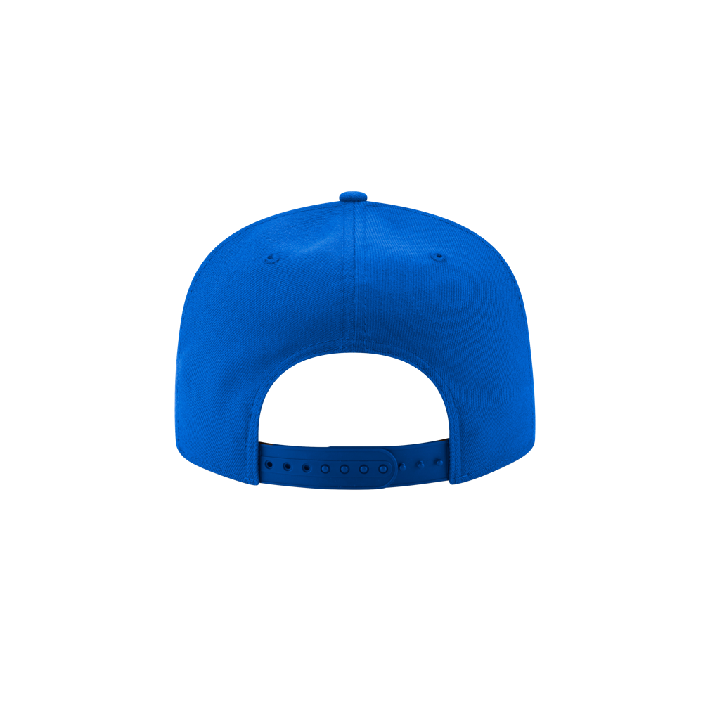 The New Era La Isla Snapback by Court Culture is displayed from the back, showcasing its royal blue color, adjustable plastic strap, and top button, all set against a plain light gray background.