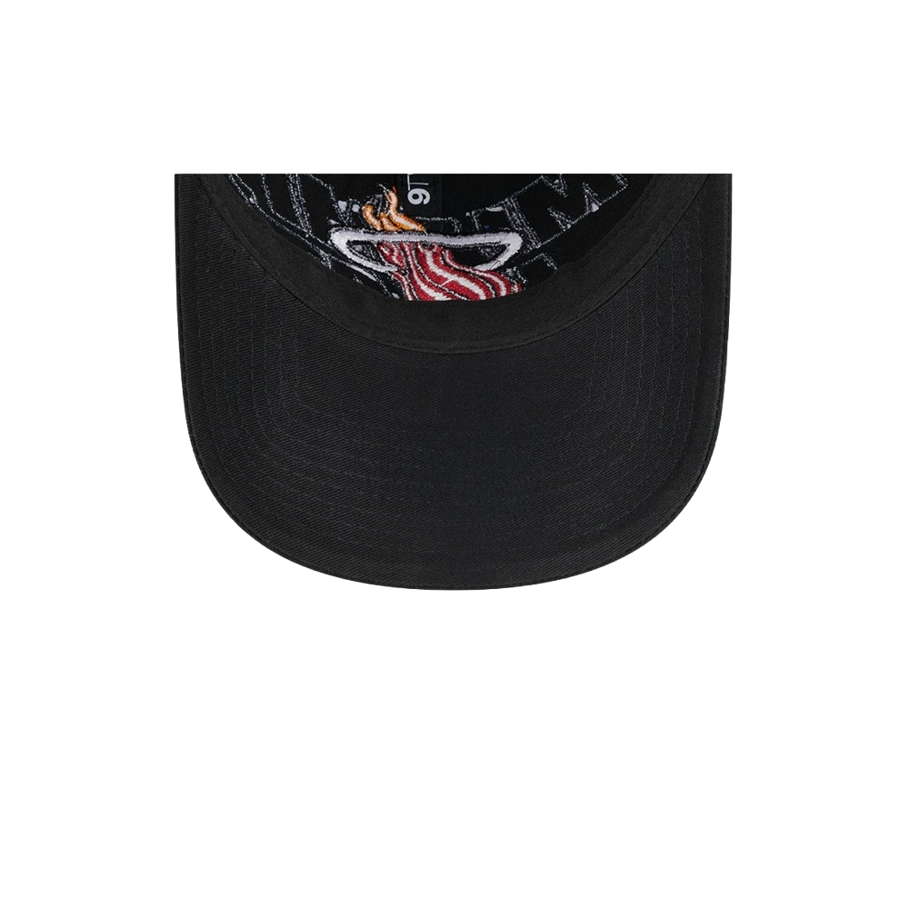 Black adjustable dad hat with Miami HEAT logo under the brim and patterned inner lining. - New Era Miami HEAT 2023 Draft Dad Hat