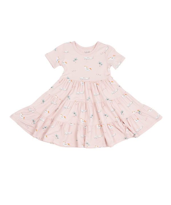 Blush pink tiered dress with short puff sleeves and subtle floral print for toddlers.