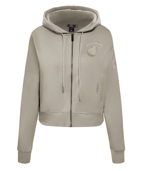 The Pro Standard Miami HEAT Original Vice Nights Beige Women's Hoodie features a cropped fit, zip-up front, drawstring hood, embroidered team logo, and text details. Made from a cotton-polyester blend; wash with like colors.