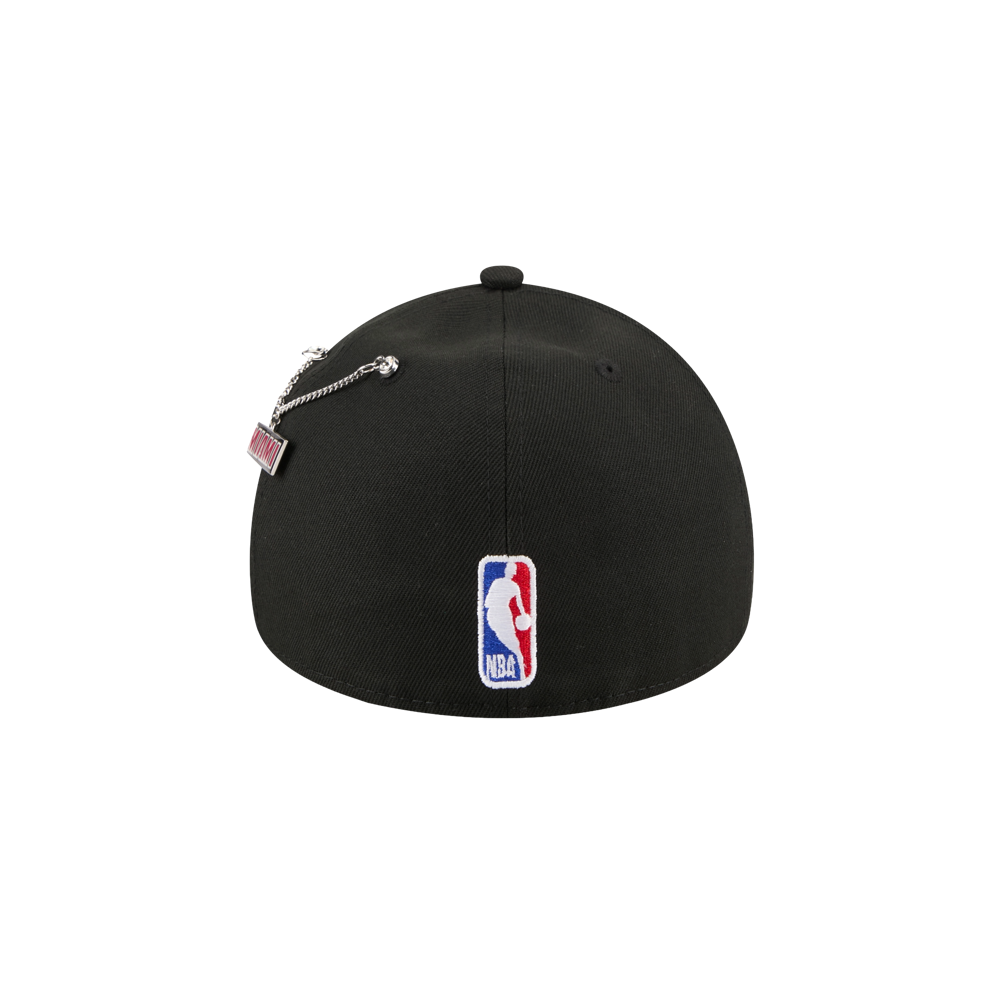 Back view of the New Era Miami HEAT 2026 Draft Fitted cap in black polyester, featuring an embroidered NBA logo in white, red, and blue at the center bottom and a small tag on a silver chain. Spot clean to keep its fitted shape.