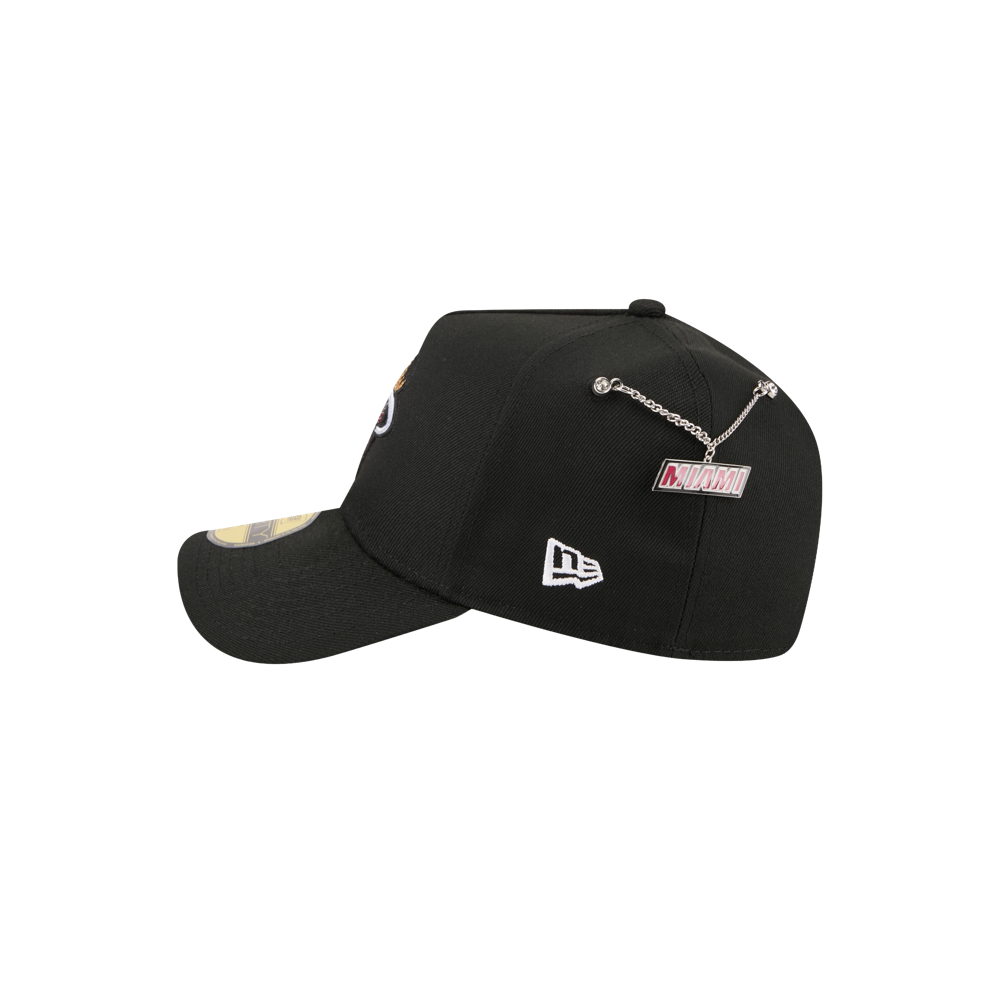 The New Era Miami HEAT 2026 Draft Fitted is a black polyester cap with embroidered patches, including the New Era logo and Miami label. It features a metal chain detail on the back and should be spot cleaned only.
