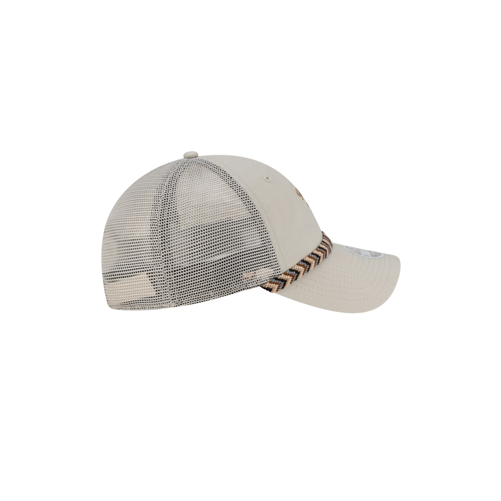 Side view of the New Era Miami HEAT Fishtail Women's Trucker Hat by New Era, featuring light beige cotton front panels, polyester rear panels, and a zigzag patterned band above the visor.