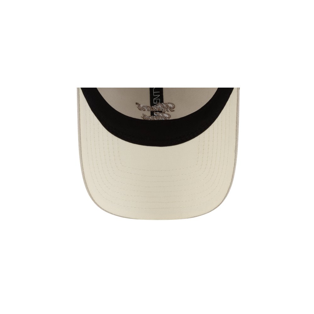 The New Era Miami HEAT Fishtail Women's Trucker Hat features beige cotton front panels, a black inner rim, visible brim stitching, and durable polyester rear panels. One size fits most for comfort and style.