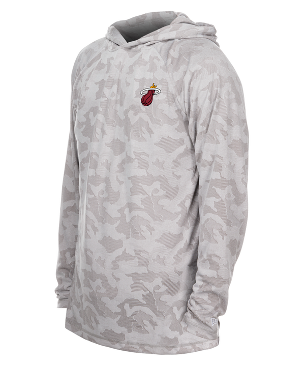 The New Era Miami HEAT Camo Hooded Long Sleeve Tee features a light gray camo pattern, polyester standard fit, long sleeves, and a small red and yellow Miami HEAT logo on the left chest, shown on a plain white background.