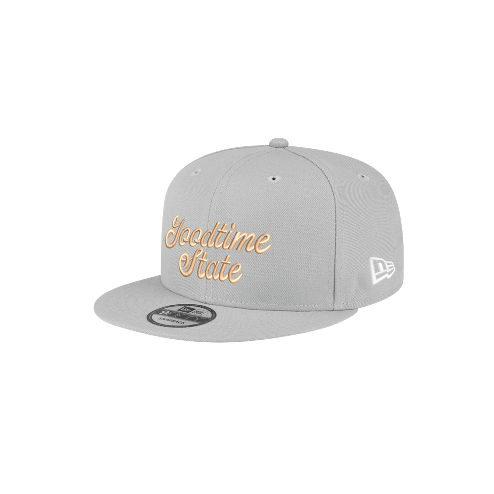 The Court Culture x New Era Vice City Goodtime State Snapback is a light gray, 100% polyester cap with beige cursive embroidery, white New Era logo, and one-size-fits-most fit, shown on a plain white background.