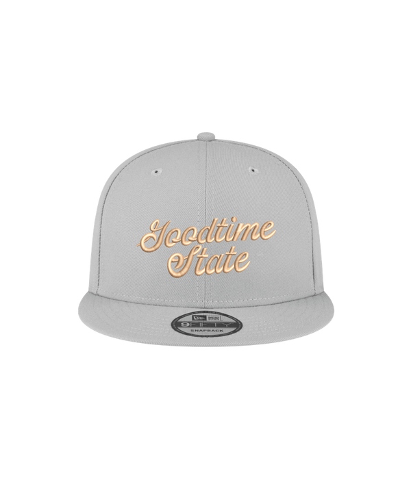The Court Culture x New Era Vice City Goodtime State Snapback is a light gray 100% polyester cap, yellow cursive embroidery, flat brim, one size fits most. Shown on a white background. Spot clean only.